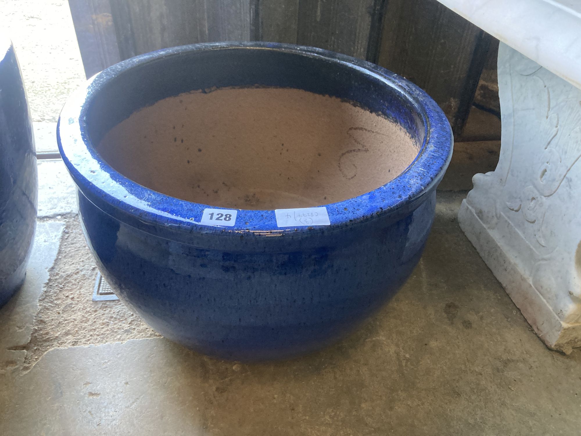 Two circular blue glazed garden planters, larger 50cm diameter, 30cm high